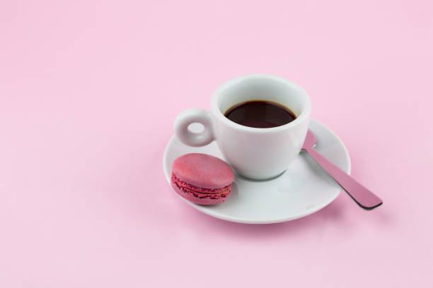 istock Close-Up Of Coffee With Macaroon Over Pink Background 1012090342