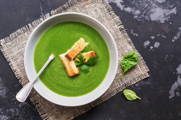 istock Soup cream with spinach. Green vegetarian vegetable soup puree. Flat lay,top view 1012091118