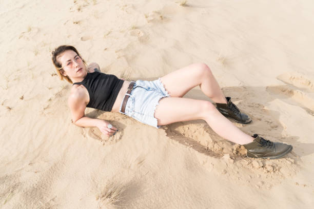 istock Woman lying in the sand 1012100352