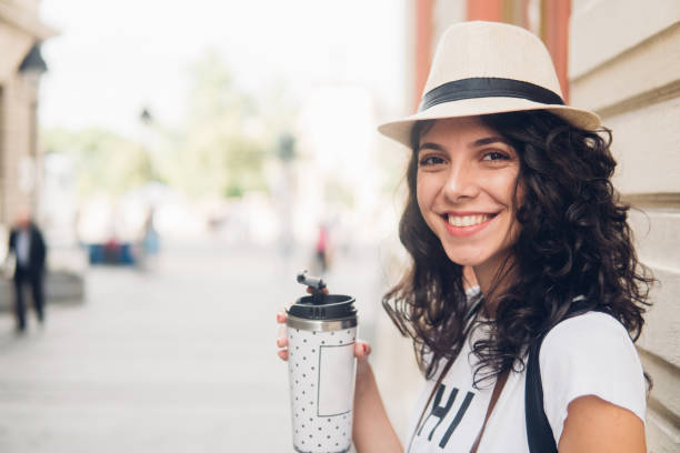istock Smiling woman holding mug of coffee 1012103052