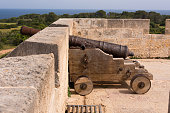 Old antique iron cannon on the old defence tower of Punta de N'Amer near Sa Coma, on the Spanish Balearic Mediterranean island of Mallorca