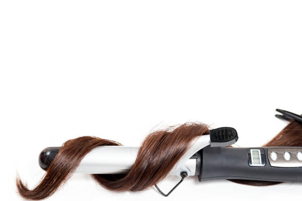 istock Curly dark hair with a curling iron isolated on white background 1012114118