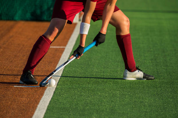 istock Low Section Of Player Playing Hockey On Field 1012116700