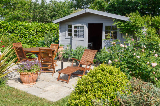 Shed with terrace and garden furniture Gray shed with terrace and wooden garden furniture shed stock pictures, royalty-free photos & images