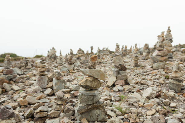 stones stacked one on the other. instalation near the memorial naval aviation cape of the goat, france - stacking stone rock full imagens e fotografias de stock