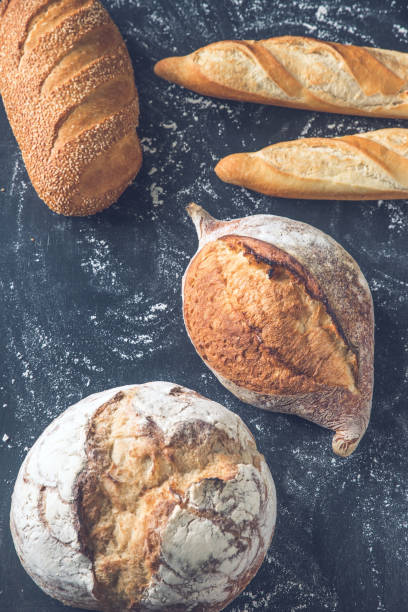istock Different kinds of bread on the wooden background 1012144936