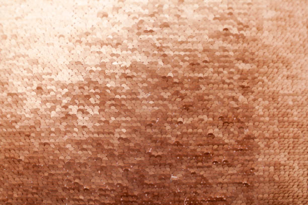 istock Sequins close-up macro. Abstract background with gold sequins color on the fabric. 1012145042
