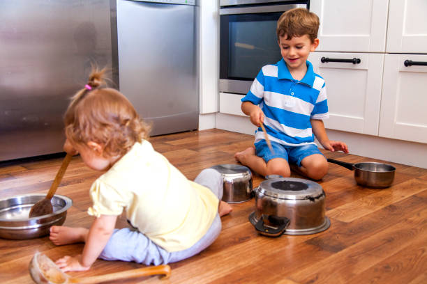 istock two children playing with cooking pan 1012146518