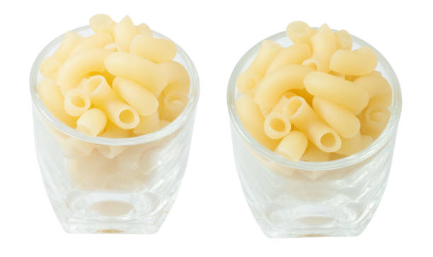 istock Cups of Raw Elbow Macaroni on White 1012146570