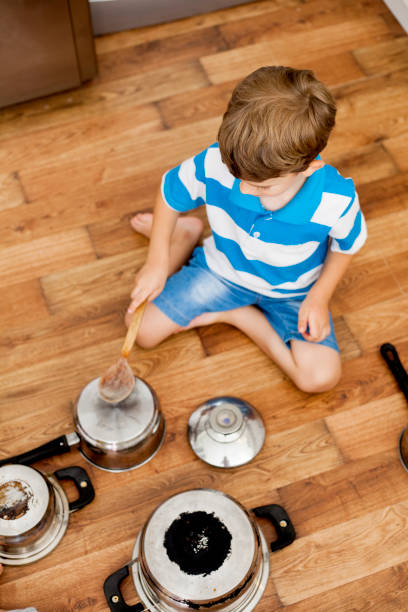 istock two children playing with cooking pan 1012158922