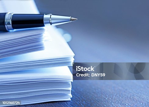 istock Ballpoint Pen Resting On Top Of Stack Of Documents 1012160724