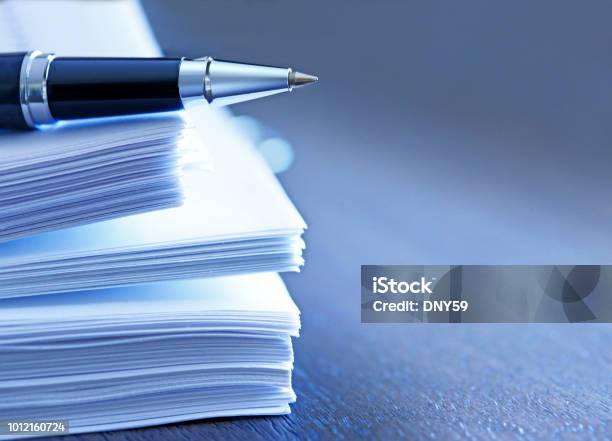 Ballpoint Pen Resting On Top Of Stack Of Documents Stock Photo - Download Image Now - Document, Legal Document, Paper