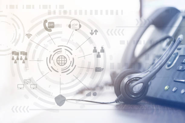 istock close up focus on call center headset device at headset VOIP system with virtual interface of futuristic symbol technology at office desk for hotline telemarketing and network operation concept 1012160928
