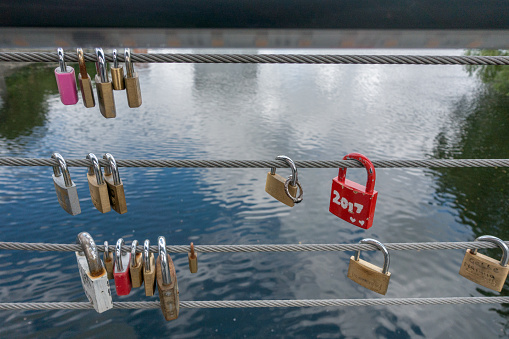 Norrkoping, Sweden, June 5, 2017: Padlocks on the side of a bridge in central Norrkoping, The padlocks are attached to the safety wires
