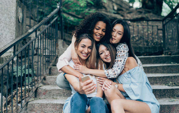 istock Multi-Ethnic Group of friends with smartphone 1012175756