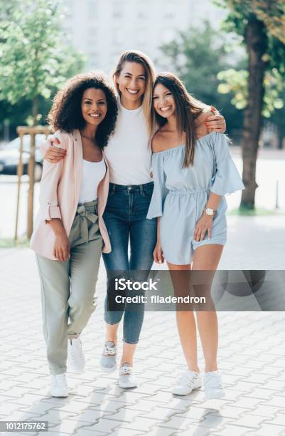 Three Girlfriends Looking Happy Together Stock Photo - Download Image Now - Women, Friendship, Girlfriend