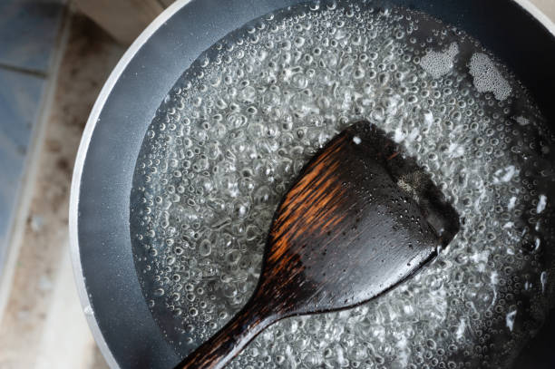 istock cooking with a pan and Wooden Turner 1012190324