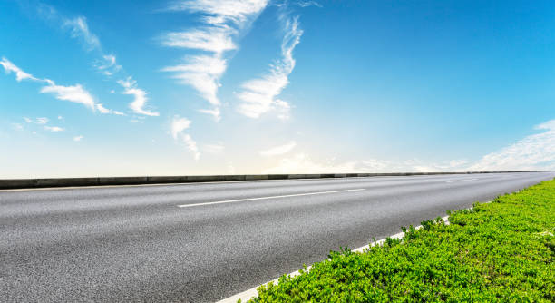 istock Clean asphalt road and beautiful sky clouds at sunrise 1012190394