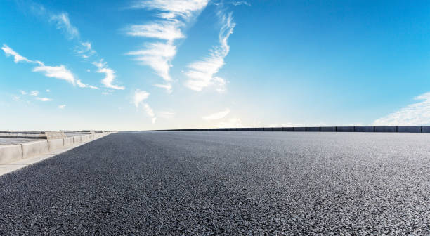 istock Asphalt road and beautiful sky clouds 1012190440