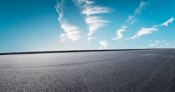 istock Asphalt road and beautiful sky clouds 1012190454