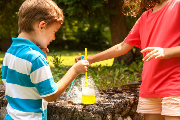 istock brother and sister blowing soap bubbles 1012200068