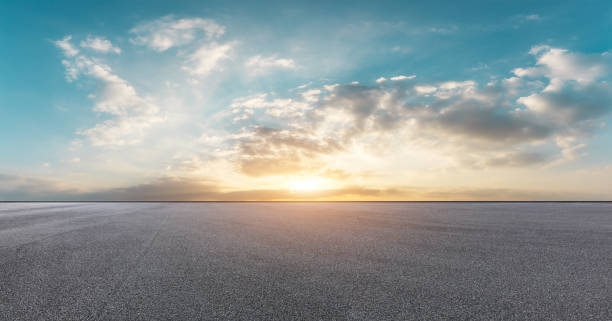 istock Empty asphalt square and beautiful colorful sky clouds 1012200172