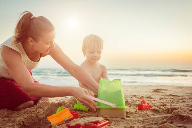 istock Happy mother and son on the beach 1012202532