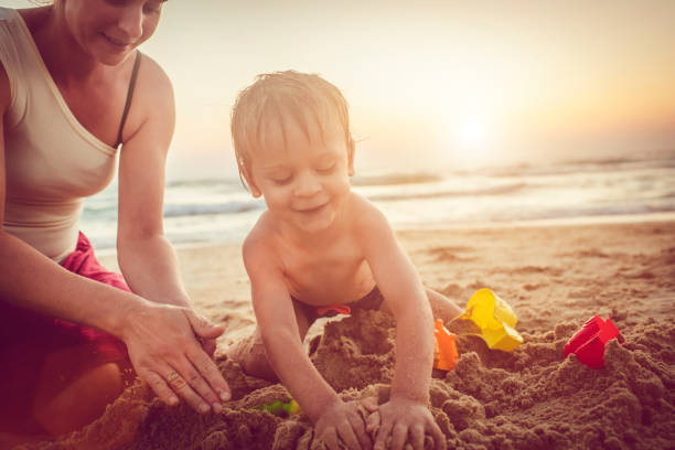 istock Happy mother and son on the beach 1012202558