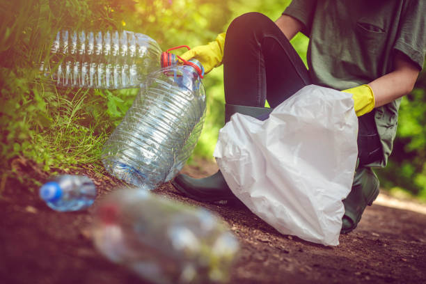 istock Volunteer collects plastic bottles outdoors 1012202862