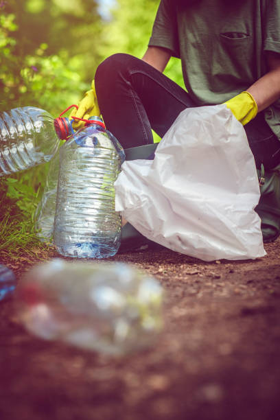 istock Volunteer collects plastic bottles outdoors 1012202864