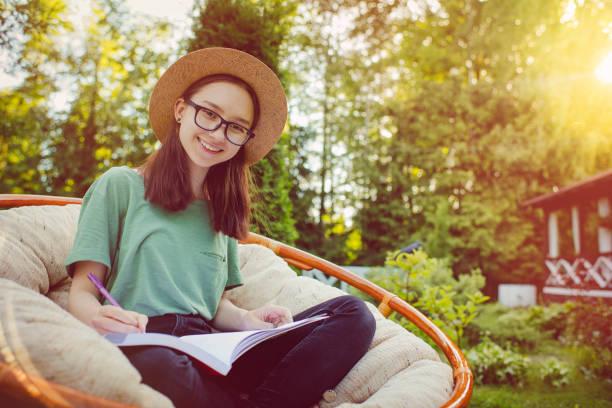 istock Teenage girl studying in back yard 1012202974