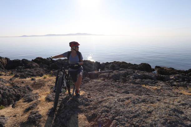 istock Mountain biker carries bike over difficult terrain 1012205842