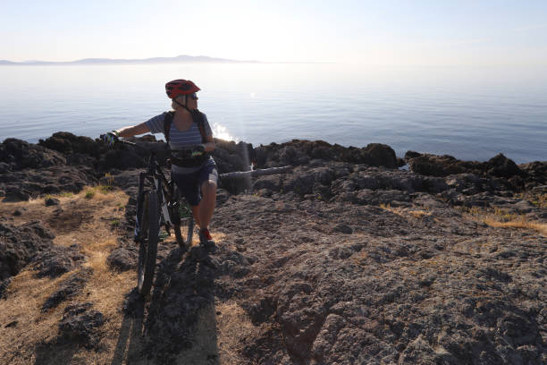 istock Mountain biker carries bike over difficult terrain 1012205862