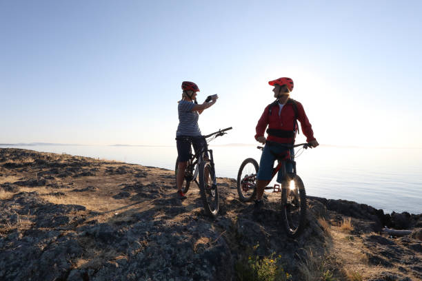 istock Mountain biker couple take photo with smart phone 1012205900