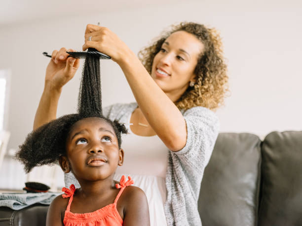istock A Mother Doing Daughter's Hair 1012208342