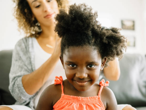 istock A Mother Doing Daughter's Hair 1012208348