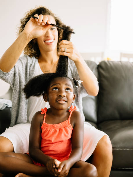 istock A Mother Doing Daughter's Hair 1012208400