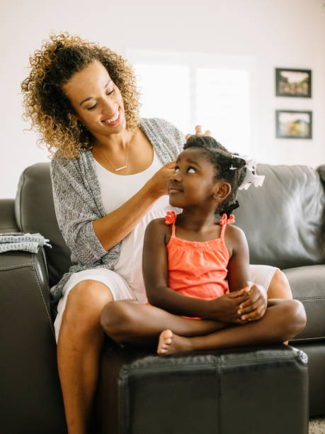 istock A Mother Doing Daughter's Hair 1012208426
