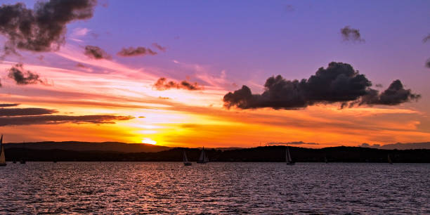 istock Yellow orange colored stratus cumulus cloud, sunset seascape. 1012220704
