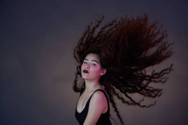 istock Brunette woman with flying hair 1012225552