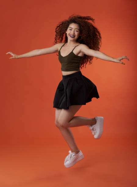 istock Jumping young woman 1012225576