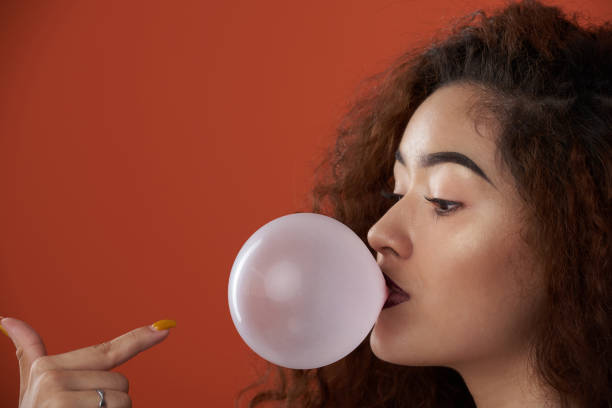 istock Young woman blow bubble gum blow 1012225582