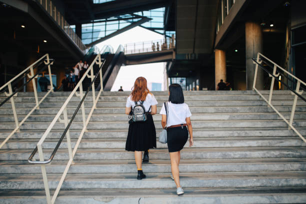 istock Two young Asian students in uniforms arriving at school or university 1012225680