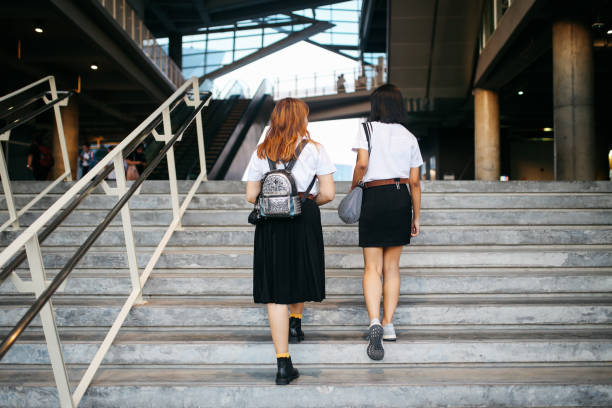 istock Two young Asian students in uniforms arriving at school or university 1012225748