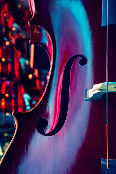 Abstract cello image showing the f hole Close up of contrabass on stage, bokeh background violin f hole stock pictures, royalty-free photos & images