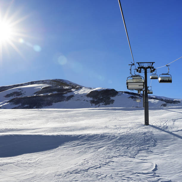 istock Chair-lift and blue sky with sun 1012232688