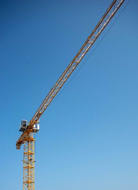 istock Industrial Construction Crane and Clear Blue Sky 1012257770