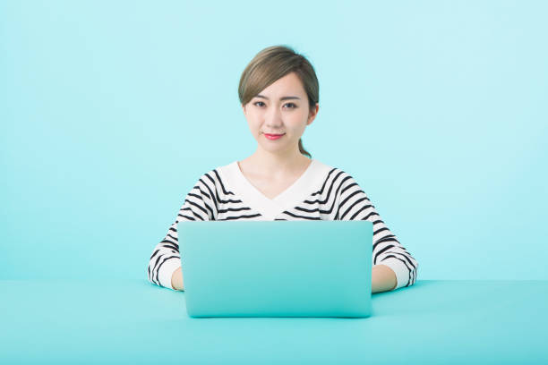 istock Young woman using laptop computer with happy face 1012259930