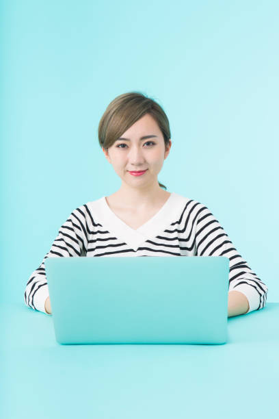 istock Young woman using laptop computer with happy face 1012259938