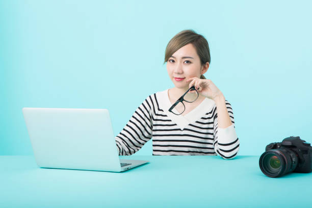 istock Young woman using laptop computer with happy face 1012259944